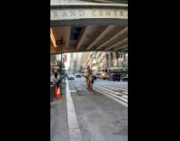 Collab WINY - Man crossing street wearing piles of clothes