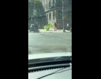 Man doing dragon ribbon dance on street 
