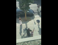 Woman handstand walk and twerks at the sidewalk