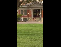 Two girls jump shot public library stairs