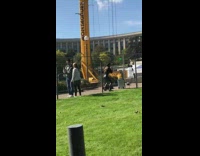 Woman in black leather outfit tiktok dance near the construction site