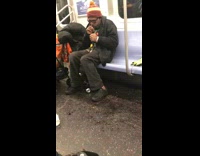 man lights up crack pipe on subway