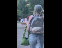 A duck sits inside girls clear backpack