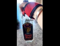 Woman straps hand on Rumple Minze bottle