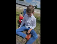 Guy laughing at little boy on grass crying 