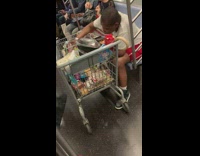 Woman brings a shopping cart full of candy bars and food onto subway
