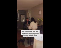 Girl eating on couch next to friends on date in living room