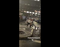 Lady in black leather does dance pose on crosswalk 