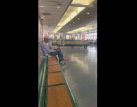 Man in grey hoodie smoking cigarette on the Staten Island ferry