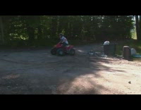 Helmet Guy Wheelies Red Four Wheeler in Grass And Falls Off
