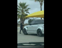 Guy black suit film grey SUV tent