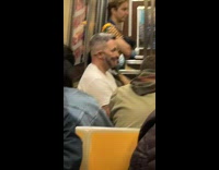 Man wear smiling print face mask subway