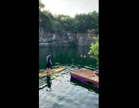 Guy tackles friend on paddleboard