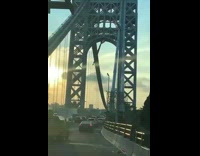 Timelapse of video being hung on busy bridge
