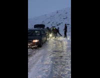 Two women selfies front of stuck cars