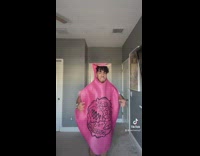 Guy in whoopie cushion pink costume 