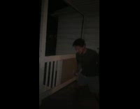 Guy smashes beer can against his face and shotguns beer on front porch