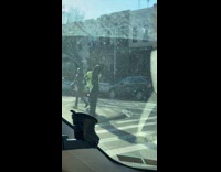 Crossing guard guy dances on sidewalk alone