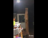 Guy offers friend red and yellow gatorade