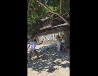 Guy and two girls dance at beach