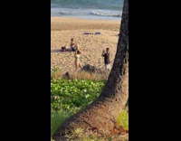 Woman in gray bikini poses at the beach at sunset