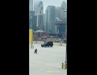 Guy black car rooftop parking lot skyline 