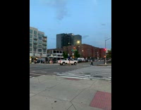 Guy crosses street on tall unicycle 