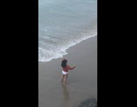 Woman brown jacket selfie photo shoot beach waves