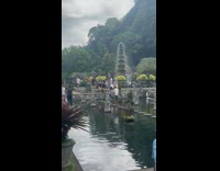 Man Dances Confidently on Temple Fountain Stone Steps