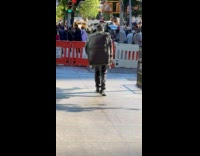 Man walking carries huge luggage as backpack