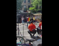 Guy dances in street with trash can on head