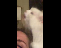 Lady Squints Face as Cat Licks her Hair