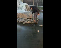 Man Stomps on Frozen Fountain and Breaks