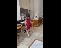 Woman grabs fries from empty table 