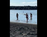Man lowers underwear and joins the photoshoot at the beach