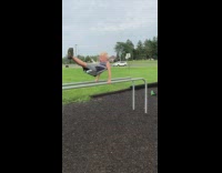 little boy in grey playground front flip fall