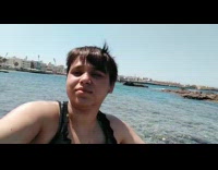 Filmer selfie video of the beach rocks of the ocean