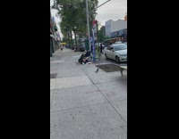 Mom changes diaper with baby laying on sidewalk 