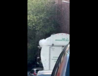 Smoke comes out from truck on street
