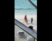 Boy photographs pink bikini mom on swing 