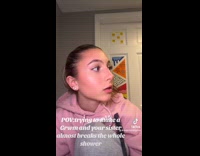 Woman filming grwm with sister inside bathroom 