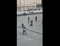 Girl coat grey pants dance on plaza