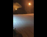 Guy rides snowmobile up ramp falls 