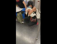 Lady picks up pet duck so guy can pet it