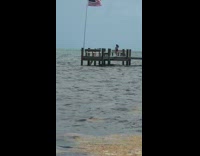 Woman tiktok dance American flag beach dock