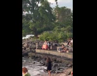 Boyfriend and girlfriend bring a table to their date with view of water 