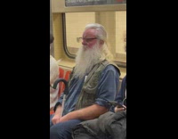 Collab WINY - Bearded guy in blue shirt sleeps on train with cane 