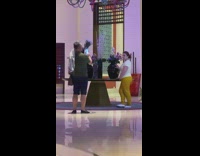 Lady Poses Besides Vase and Touches it