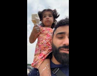 Dad carries daughter covered in ice cream