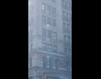 Guy cleans window on high rise building